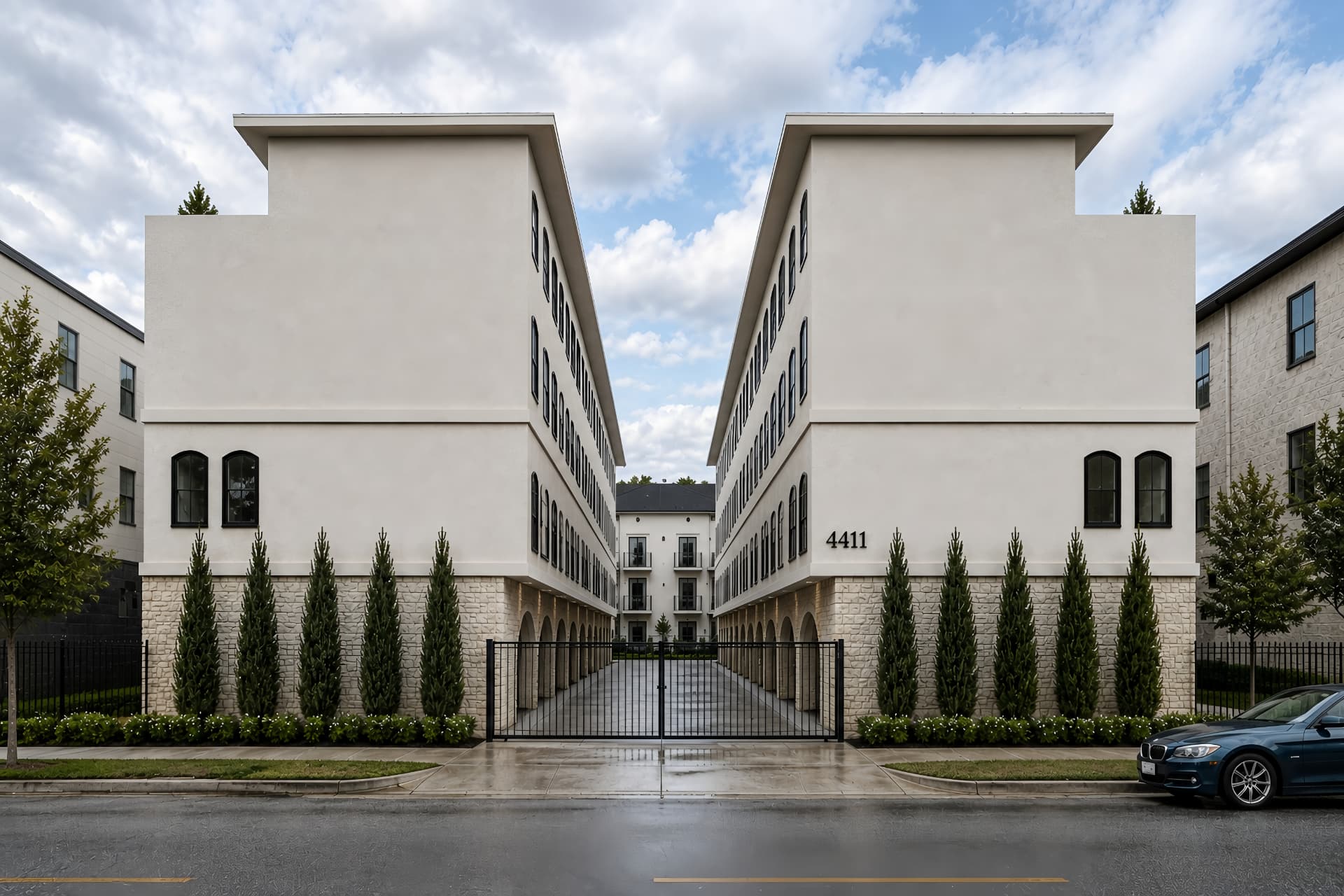 Gated motor court entry at 4411 Sylvester framed by cypress trees