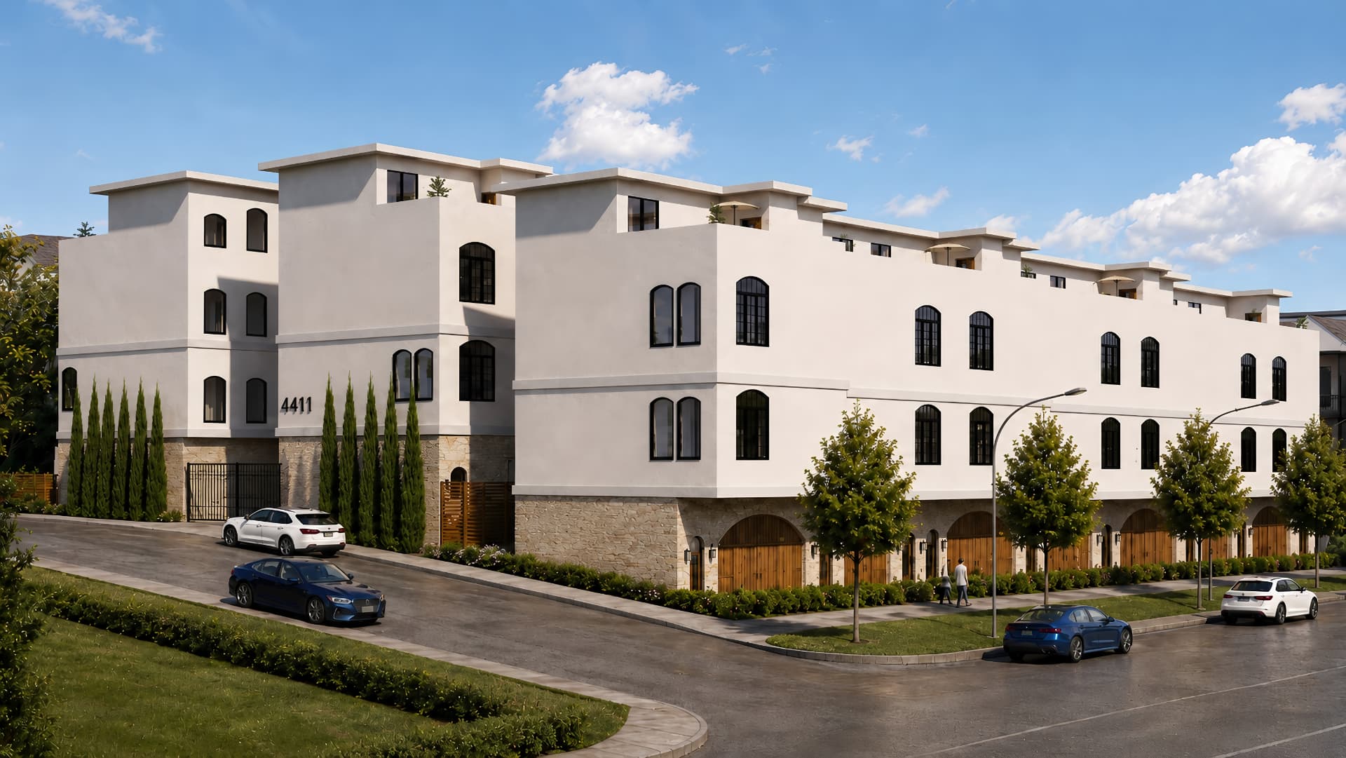The Arlow Collection townhomes in daylight with arched steel windows and limestone base